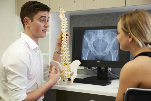Murdoch Chiropractic student with spine model