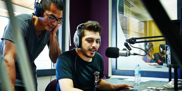 two male students broadcasting in a radio studio