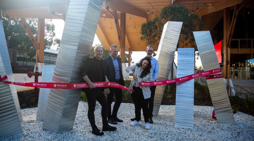 Aliesha Aden, sculptor of Stasis III cutting the ribbon after her sculpture found its permanent home next to Murdoch University's Boola Katitjin.