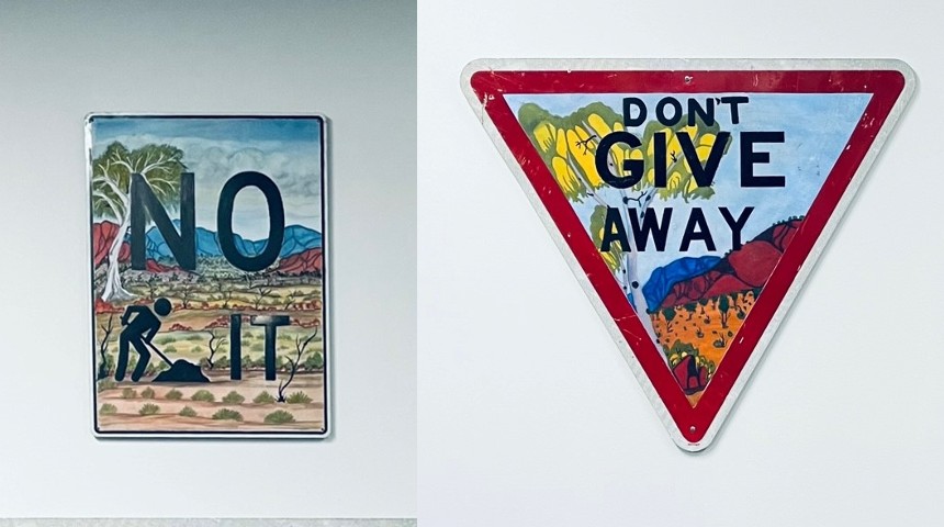 Don't Give Away and No Dig It signage artwork by Iltja Ntjarra artists.