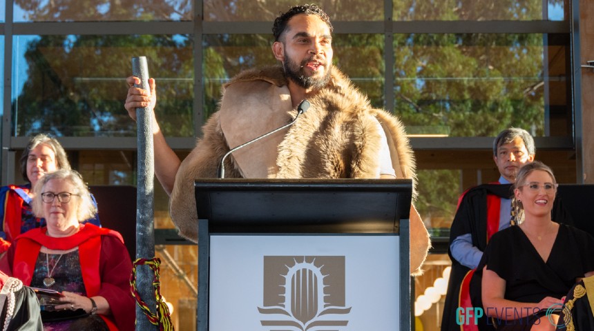 Ash Penfold, Whadjuk Noongar man, presenting the Acknowledgment of Country at 2023 Murdoch University graduations.