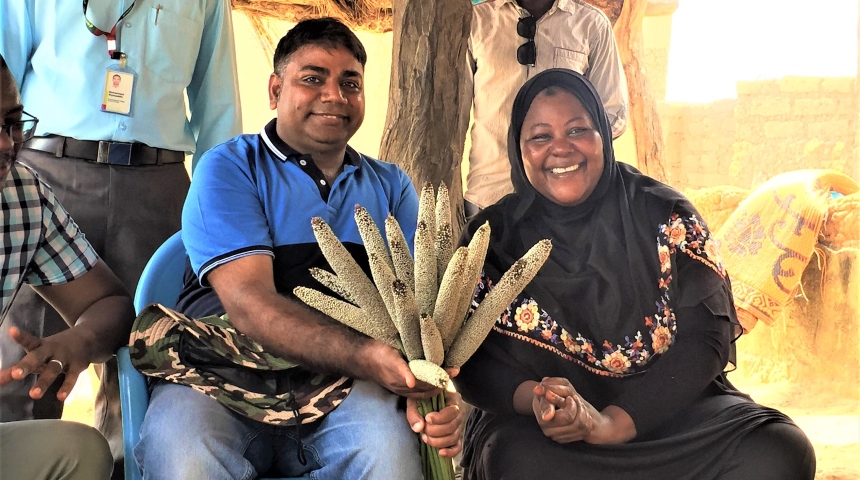 Professor Varshney with a local business entrepreneur holding a pearl millet hybrid