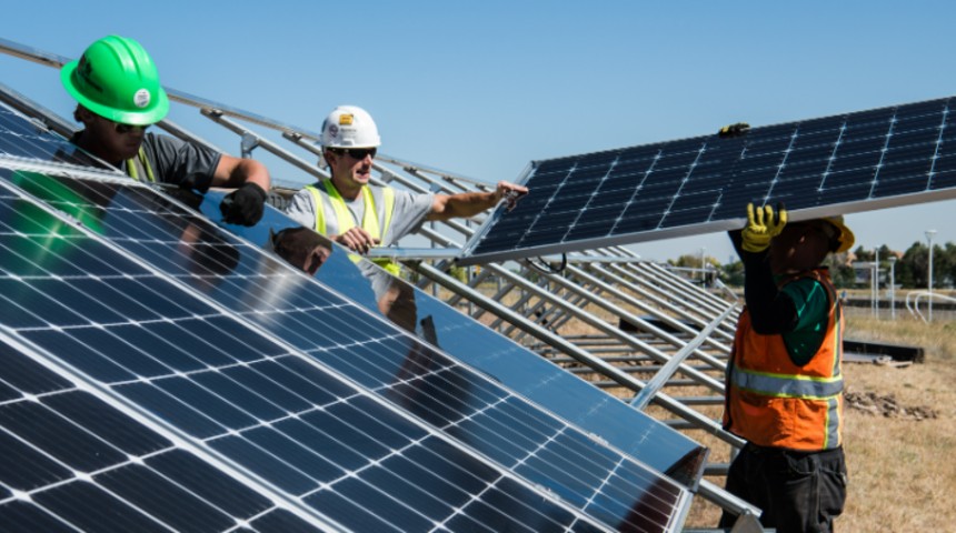 Tradesmen putting up solar panels