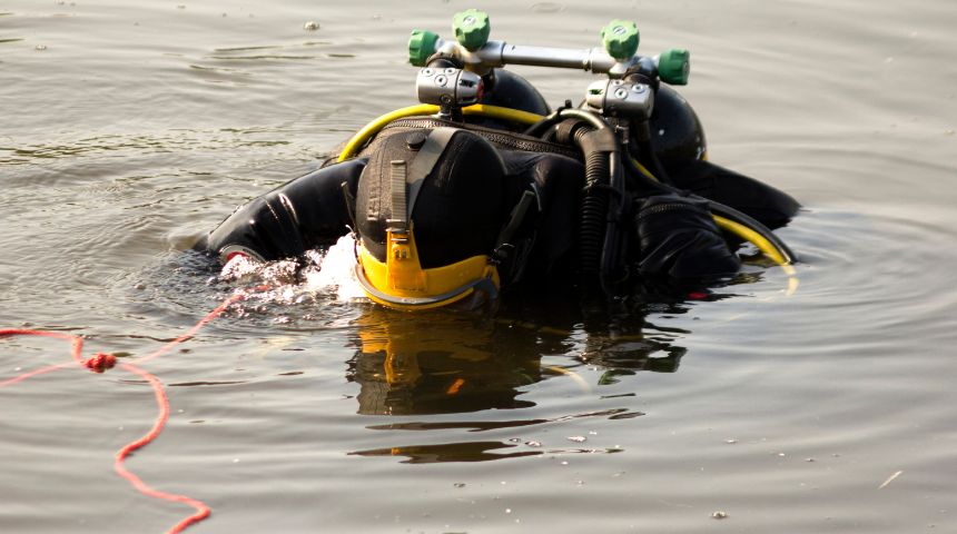 Police scuba diver on surface of water