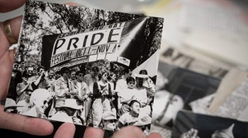 A black and white photograph from a historic pride parade