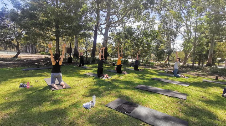 Staff and students enjoying a yoga session on Murdoch Uni's Bush Court