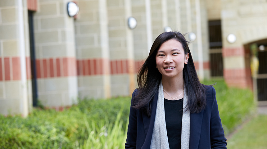 International student Andra Julinar smiling and posing in front of building at Murdoch Perth campus