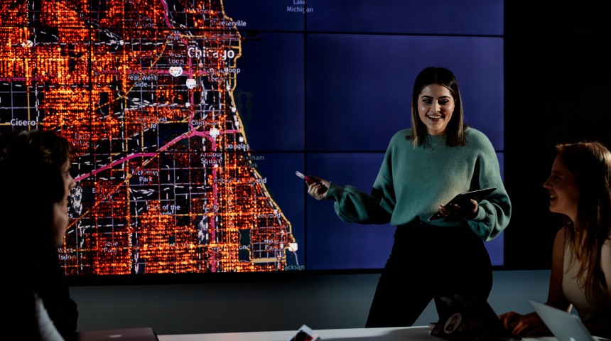 Female student presenting in front of a map of Chicago