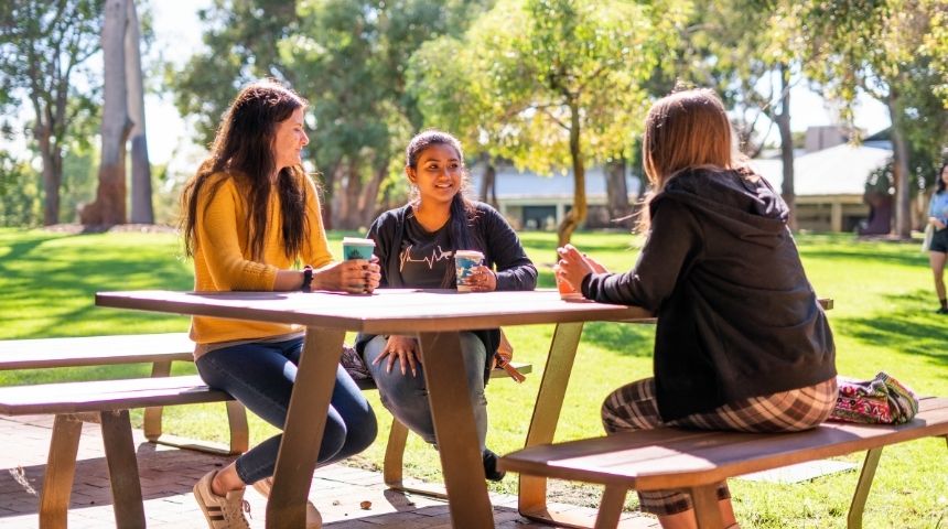 Students sitting at picnic table