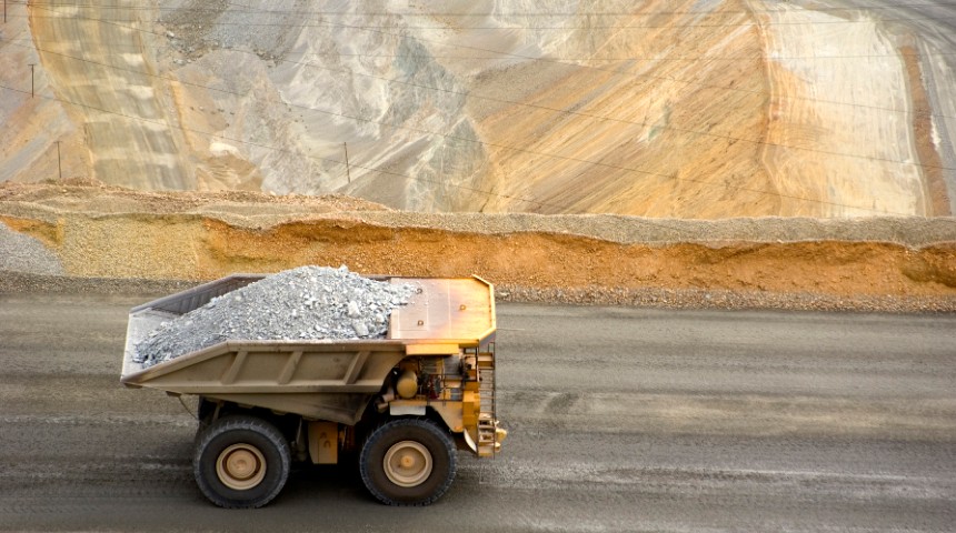 mining dump truck drives through copper mine 
