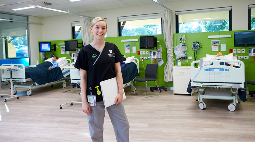 A Murdoch  University nursing student stands in the simulated ward