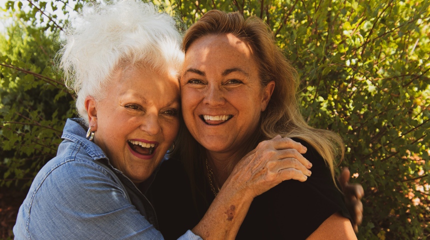 Old and young woman embracing and smiling
