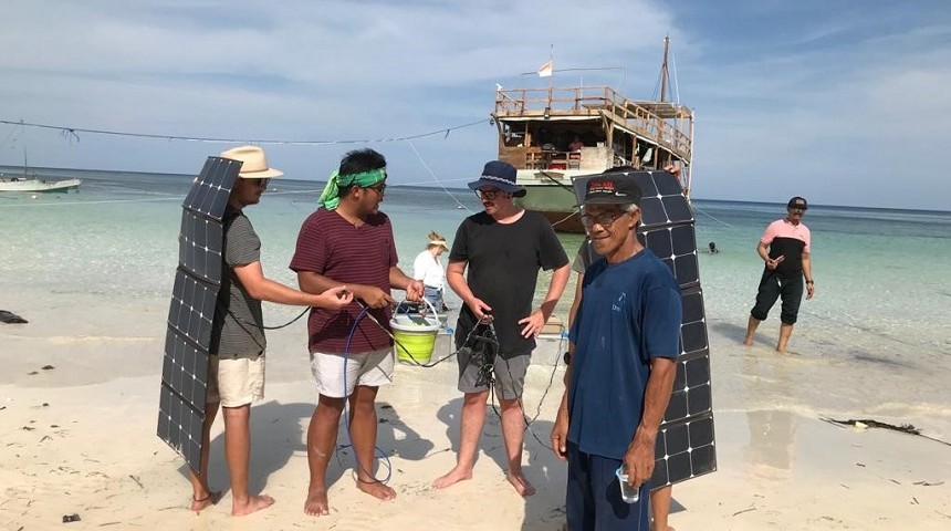 Murdoch University students demonstrate solar powered water kits to residents of  islands off Massakar, Indonesia 