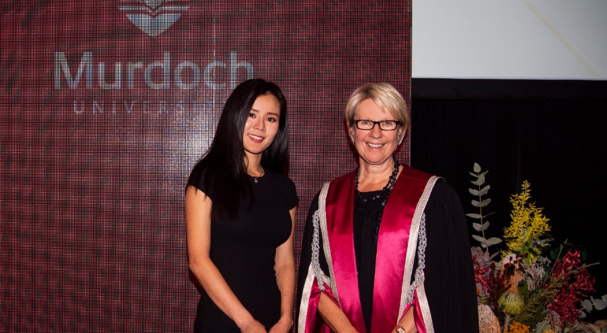 Wenna Lee and Vice Chancellor Eeva Leinonen stand in front of a banner at the VC awards