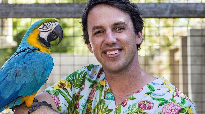 Veterinary surgeon Dr James Haberfield with a macaw on his shoulder