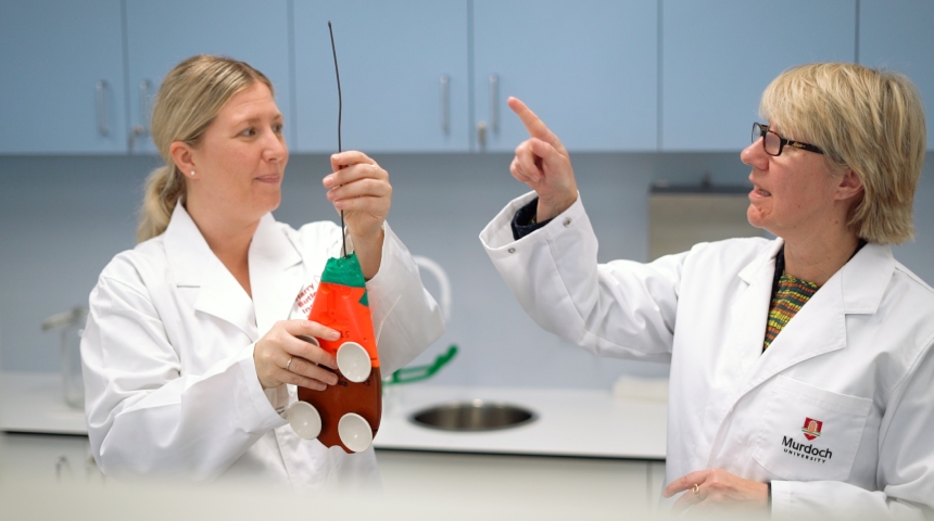 Vice Chancellor Eeva Leinonen in lab coat with scientist