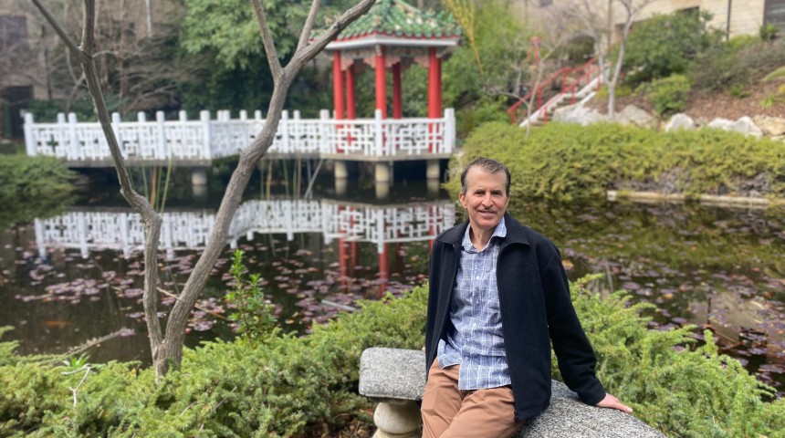 Warren sitting at the Chinese Gardens on Murdoch Campus