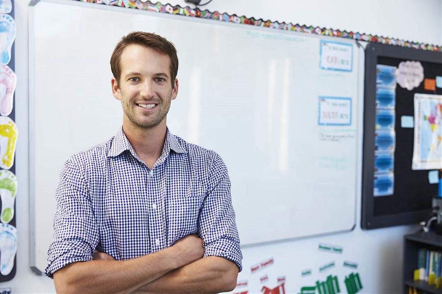 Male teacher in front of white board 
