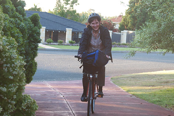 Martina Calais riding on bike in suburbs