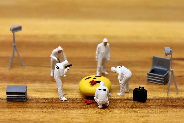 Toy figurines are assembled to create a mock crime scene