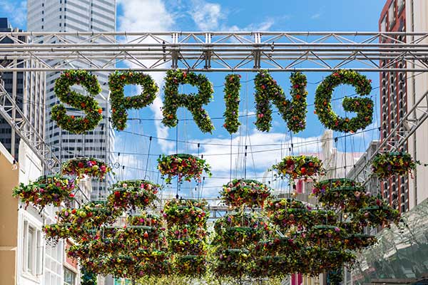 Hanging flowers that spell out spring under Perth buildings